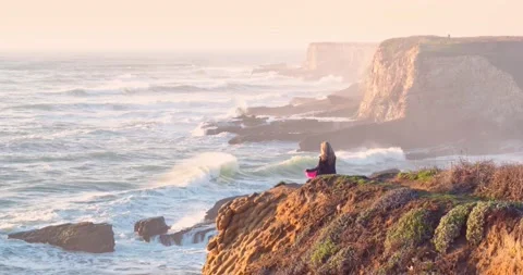 Aerial : Woman Meditating at Cliff Edge over Ocean, Panther Beach Coastline, Stock Footage