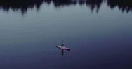 Aerial Of Woman Paddle Boarding In A Beautiful Lake Surrounded With Mountains Stock Footage