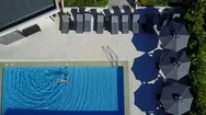 Aerial: Woman Swimming In Pool Stock Footage