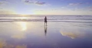 Aerial Of Woman Walking And Running On A Beach, Karekare, Auckland, New Zealand Stock Footage