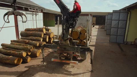 Aerial woodwork industry unloading logs from truck close up shot Stock Footage 46909323