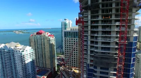 AERIAL - Worker on a construction building with an ocean view Stock Footage 65153901