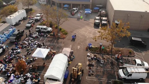 Aerial of workers loading donations at Camp Fire distribution center in Stock-Footage 98855922