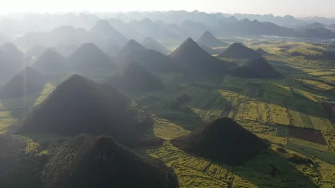 Aerial Yellow Rapeseed Fields Among Karst Mountains in Spring Stock Footage 342241836