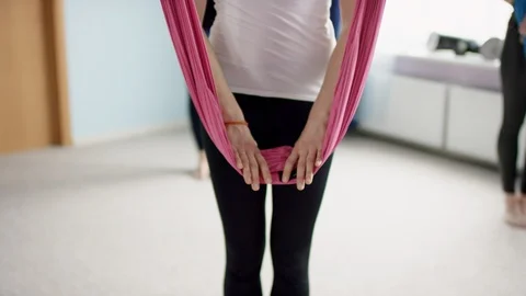 Aerial yoga class practicing baddha konasana pose Stock Footage 120942521