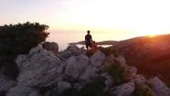 Aerial - Young Hikers Enjoying The View From Seaside Mountain Peak Stock Footage