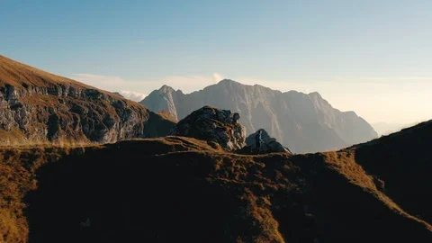Aerial - young runner in the middle of the mountains Stock Footage 104662512