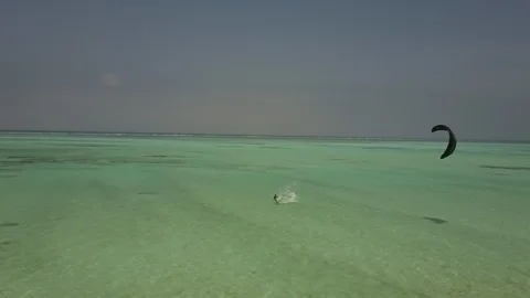 AERIAL ZANZIBAR - INDIAN OCEAN - KITESURFER FOLLOW FRONT Stock Footage