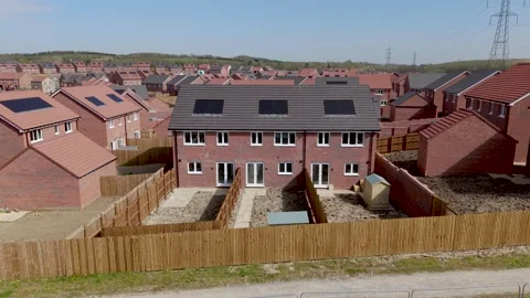 Aerial zoom into generic new build houses on a construction site in UK Video stock 332673791