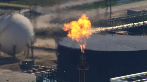 Aerial zoom-out from flare stack to oil refinery view Stock Footage 59472250