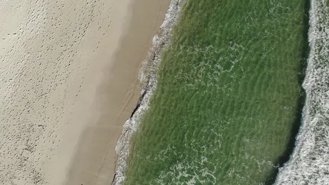 Aerial Zoom Out of Waves Crashing on Beach Stock Footage