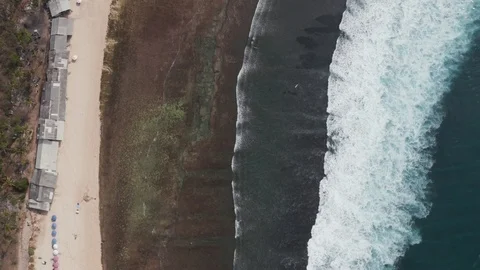 Aerial zoom of rolling waves on reef break beach in Uluwatu Bali 4K Drone Shot Stock Footage 103222363