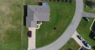 Aerial Zoom In View Man Mowing Lawn  	 Stock Footage