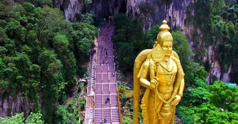 Aerial zooming in view of Entrance to Batu Caves with the Murugan statue Stock Footage