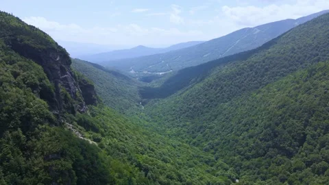 Aerial/Drone Fly Through Forest Mountain Valley on Sunny Day Stock Footage 223578030