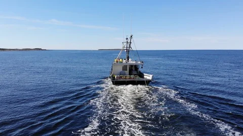 Aerial/drone of Lobster fishing boat setting gear/traps in Atlantic Ocean Stock Footage