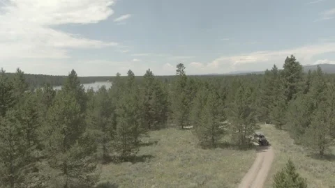 Aerial/Drone Shot ATV/UTV in Forest by River Stock Footage 274178221