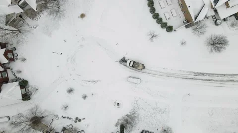 Aerial/Drone Top Down View of a Snow Plow in a Residential Neighborhood Stock Footage 236573279