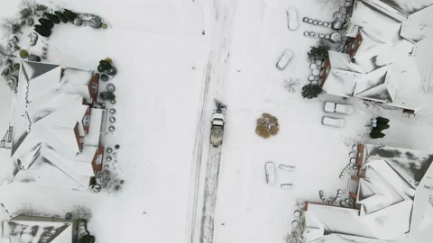 Aerial/Drone Top Down View of a Snow Plow in a Residential Neighborhood Stock Footage 236573292