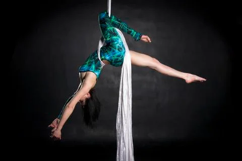 Aerialist doing tricks on silks Stock Photos