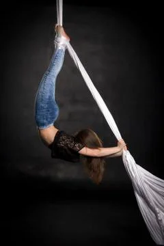 Aerialist doing tricks on silks Stock Photos