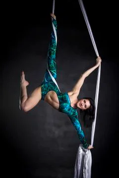 Aerialist doing tricks on silks Stock Photos