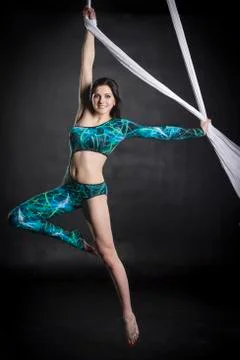 Aerialist doing tricks on silks Stock Photos