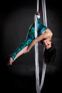 Aerialist doing tricks on silks Stock Photos