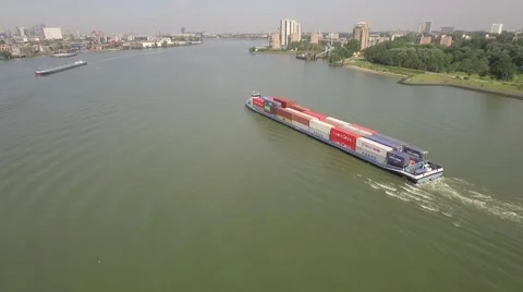Aerials Rotterdam River ship with containers enters city Stockbeeldmateriaal 58141937