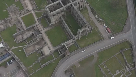 Aerials: Tintern Abbey monument plan, Wales. UK Stock Footage 306999443