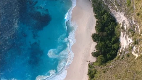 Aerial/top view of beach, sand, sea, blue ocean, waves, mountain, forest, trees Stock Footage
