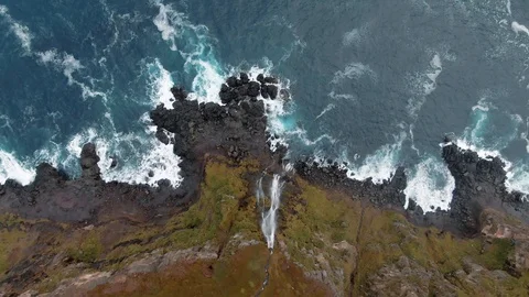 Aerialview of a stream of water falling down from a cliff top in North Iceland Stock Footage 119790420