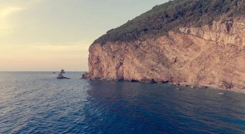 Aeriel view point of sheer cliffs raising from the sea. Stock Photos