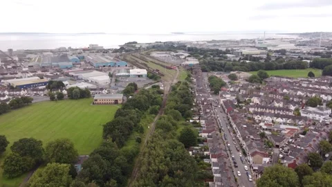Aeriel view of train tracks next to industrial estate 스톡 동영상 256598011