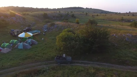 AERO: Flying over SUV, car traveling between the mountains, Jeep go off-road Stock Footage 80595010