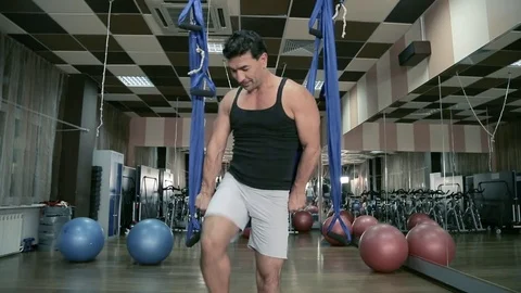 Aero yoga. A man sits on the canvas,does the splits and pulls. Stock Footage 80438052