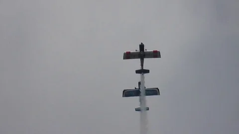 Aerobatic duo display at low level with white smoke trails Video stock 83598930