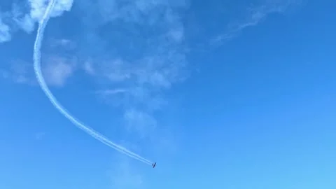 Aerobatic Jet Performing Steep Dive with White Smoke Trail Stock Footage 344947305