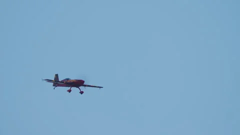 Aerobatic plane flying a low level pass Stock Footage 346224224