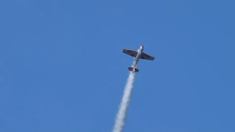 Aerobatic plane performs a loop and crosses with another at the base Stock Footage 167909930