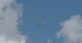Aerobatics glider HK36 TTC Super Dimona flying overhead in blue sky with clouds 4k or 4k+ Resolution