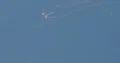Aerobatics glider pulling white smoke lines from wings in the blue sky 4k or 4k+ Resolution
