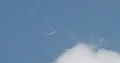 Aerobatics glider pulling white smoke lines from wings in the blue sky 4k or 4k+ Resolution