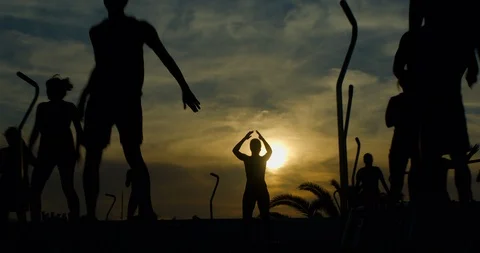 An Aerobics class using trampolines in the sun. Video stock 85538461