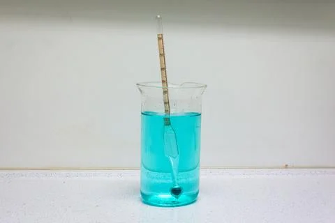 Aerometer in a glass with liquid Stock Photos