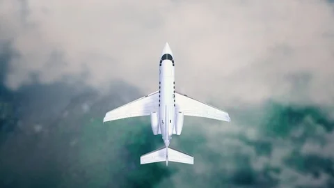 Aeroplane Flying Through Clouds in the blue sky through sunshine and clouds in Stock Footage 121801871