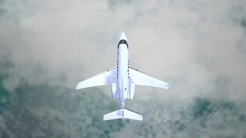 Aeroplane Flying Through Clouds in the blue sky through sunshine and clouds in Stock Footage 121802145