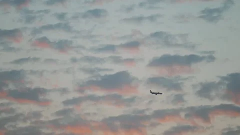 An aeroplane flying through pastel clouds over Riyadh Stock Footage 305351713