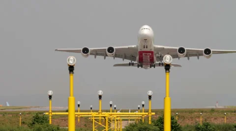 Aeroplane takes off over landing lights emirates airbus, a380 Stock Footage 25930682