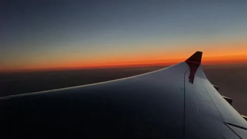 Aeroplane window wing view at sunset Stock Footage 245569638